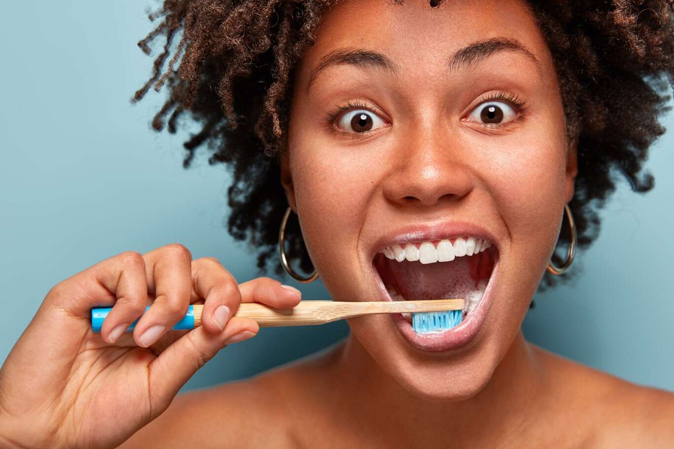 A dentist performing a professional dental cleaning on a patient to maintain oral health and prevent gum disease.